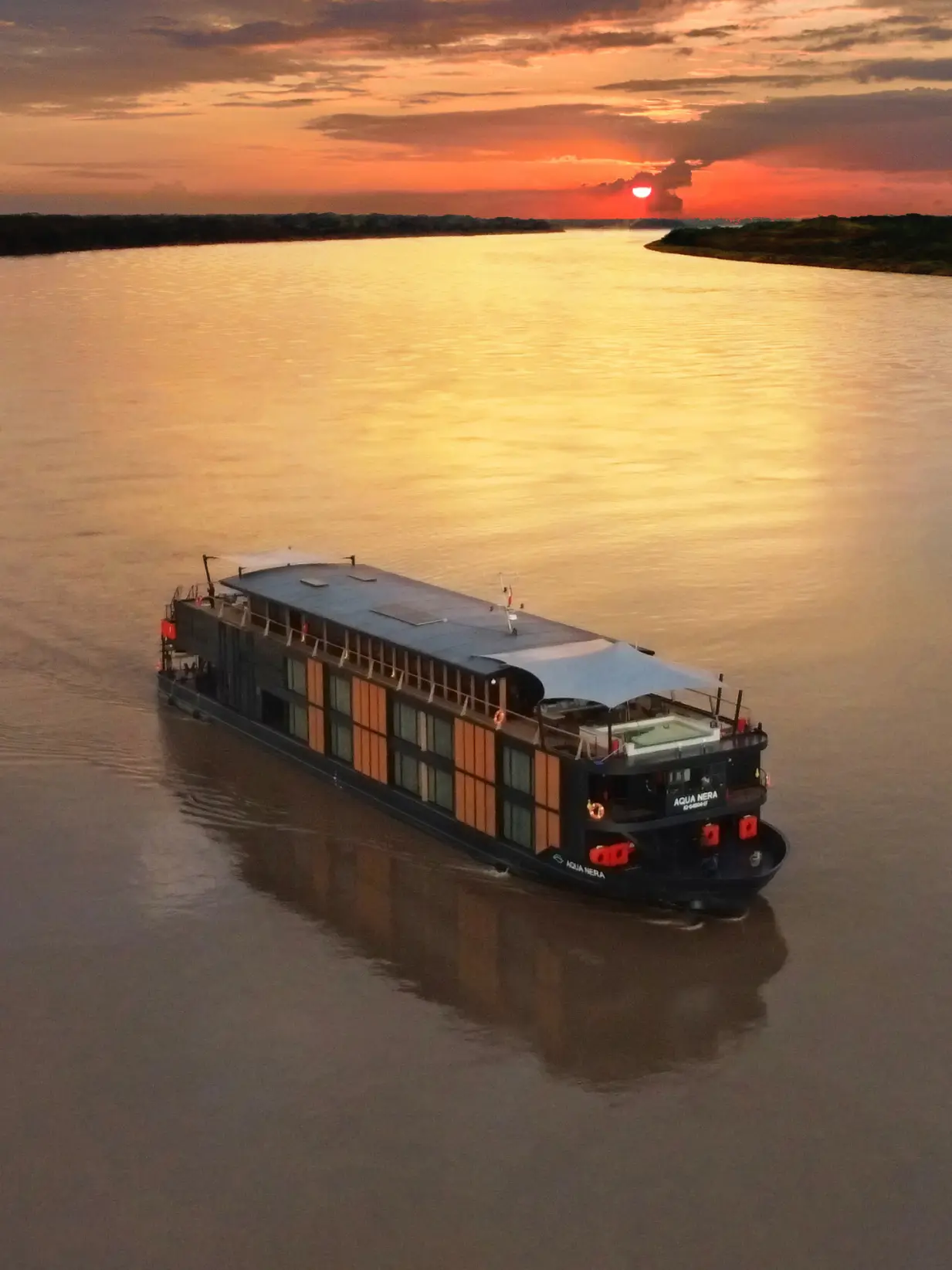Aqua Nera expedition ship on the Amazon at sunset